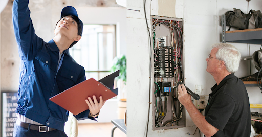 A home inspector checks a fusebox.