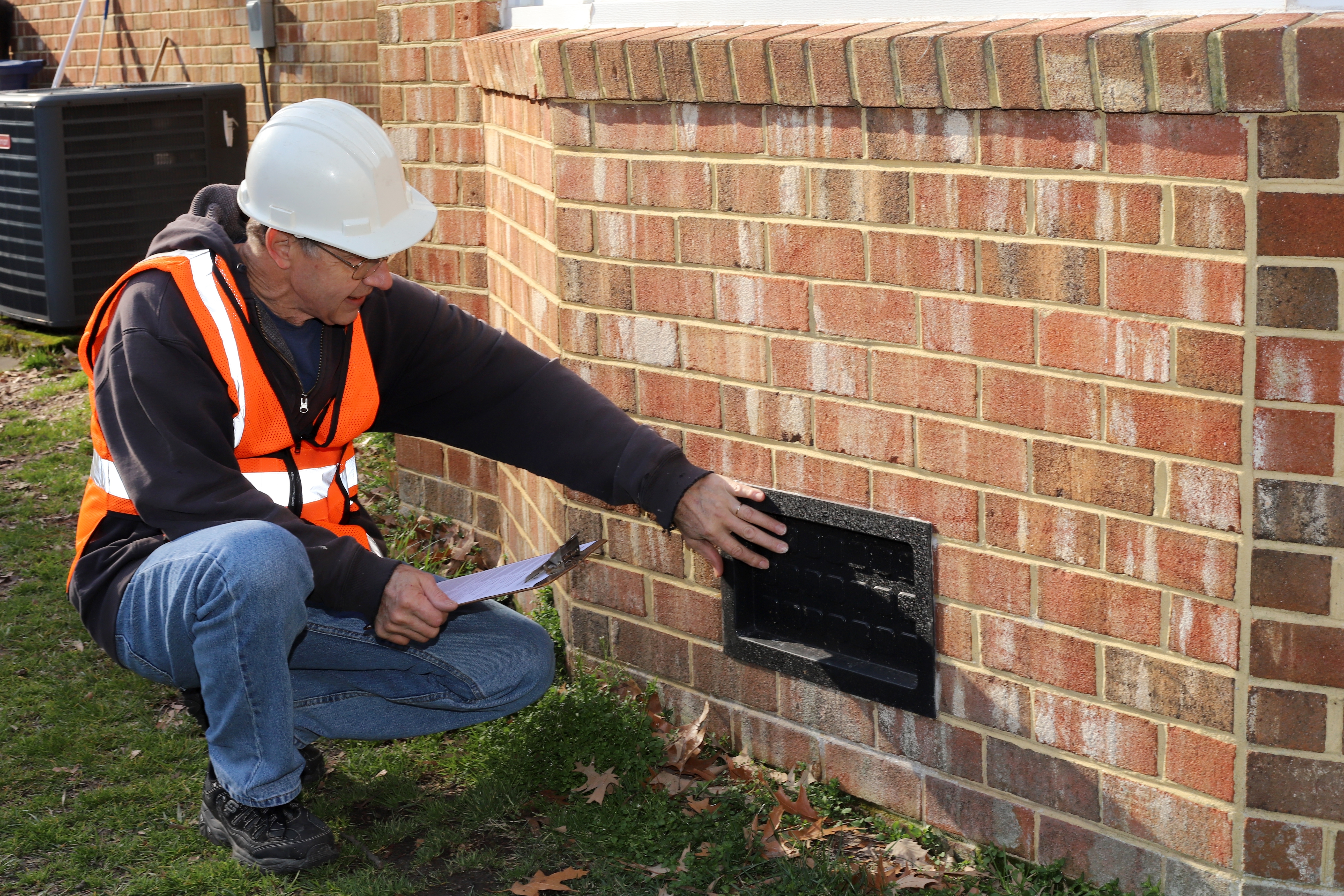 A home inspector checks a fusebox.